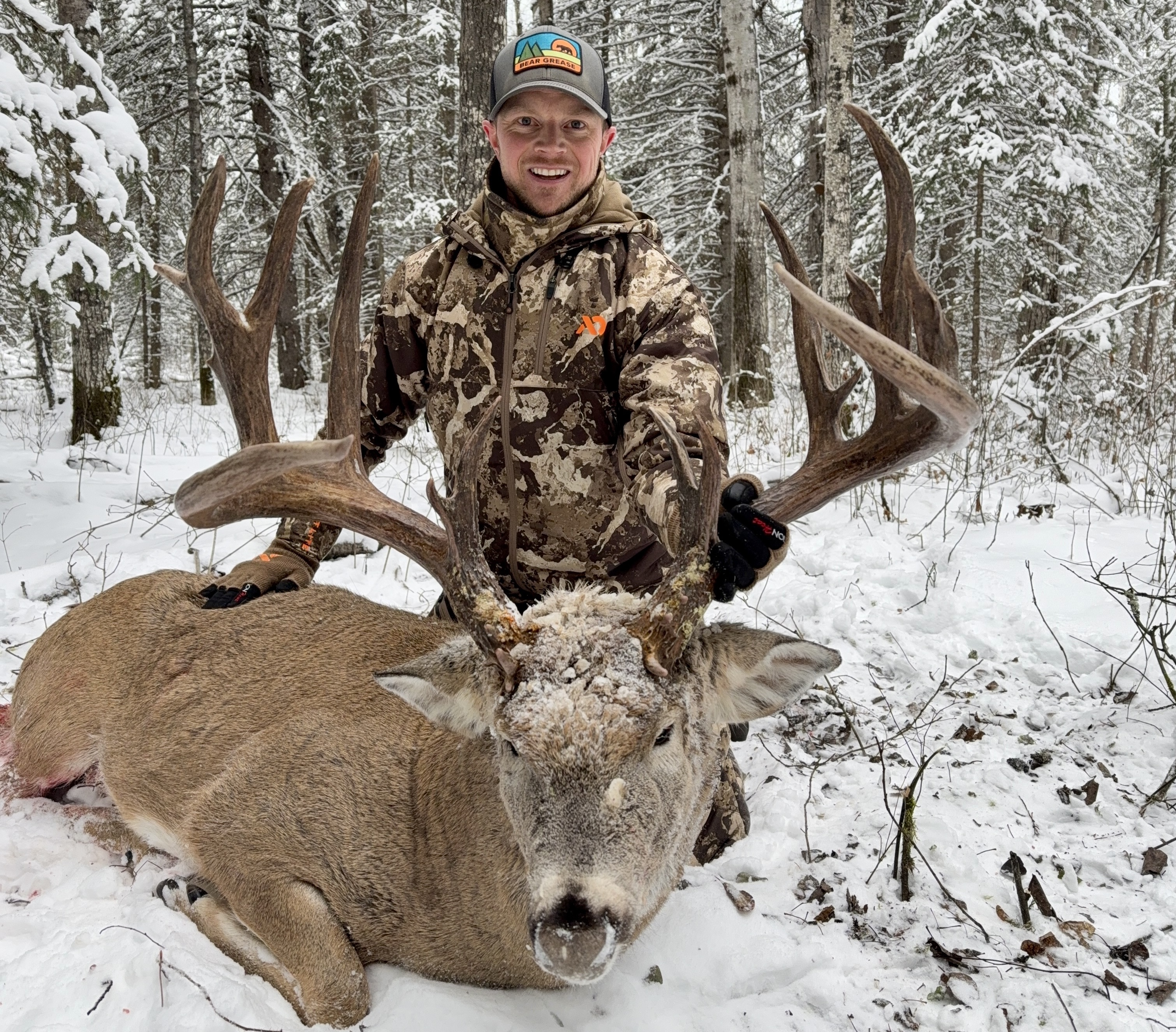 A hunter postes with a trophy whitetail buck taken in Alberta. 