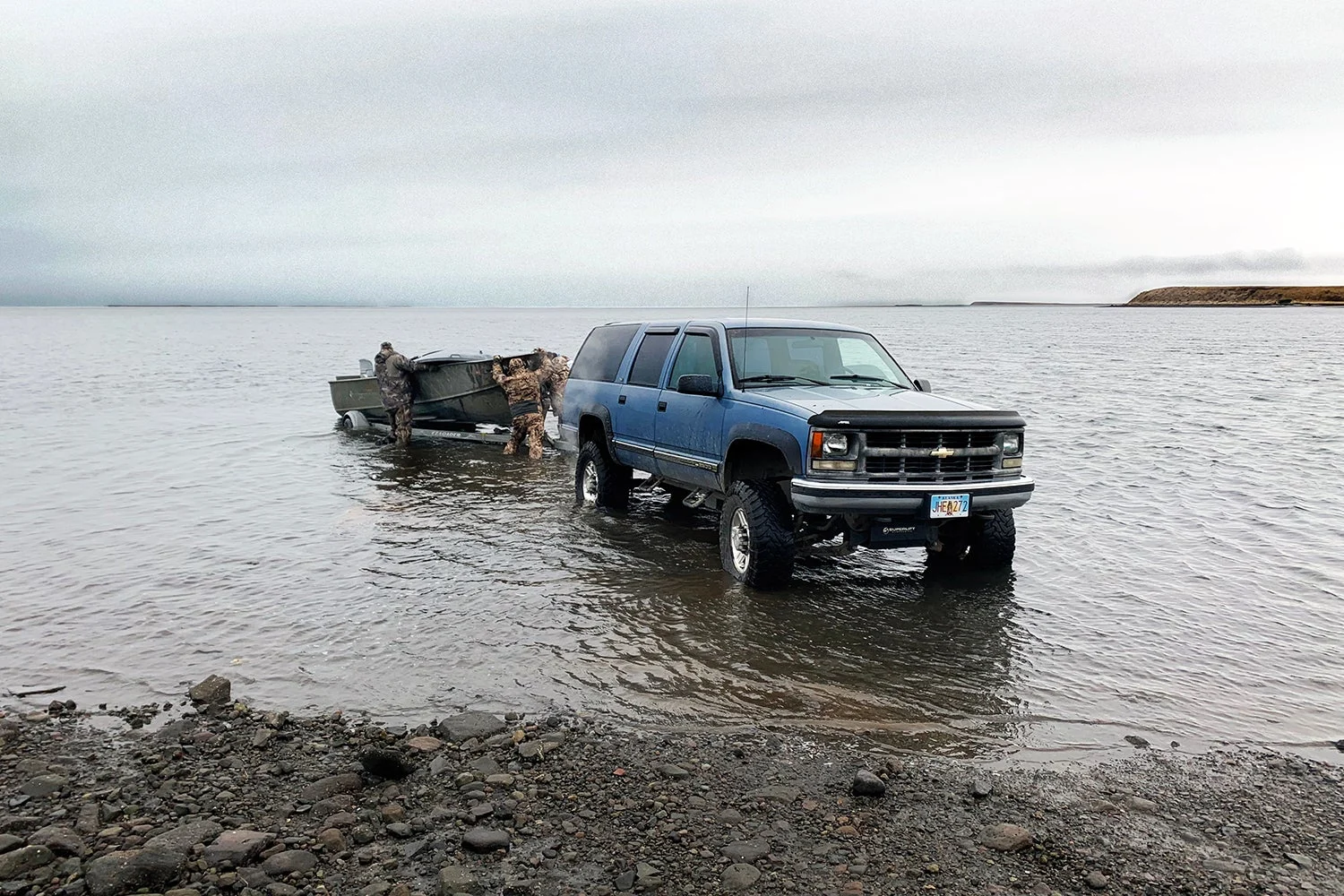 truck towing boat into water