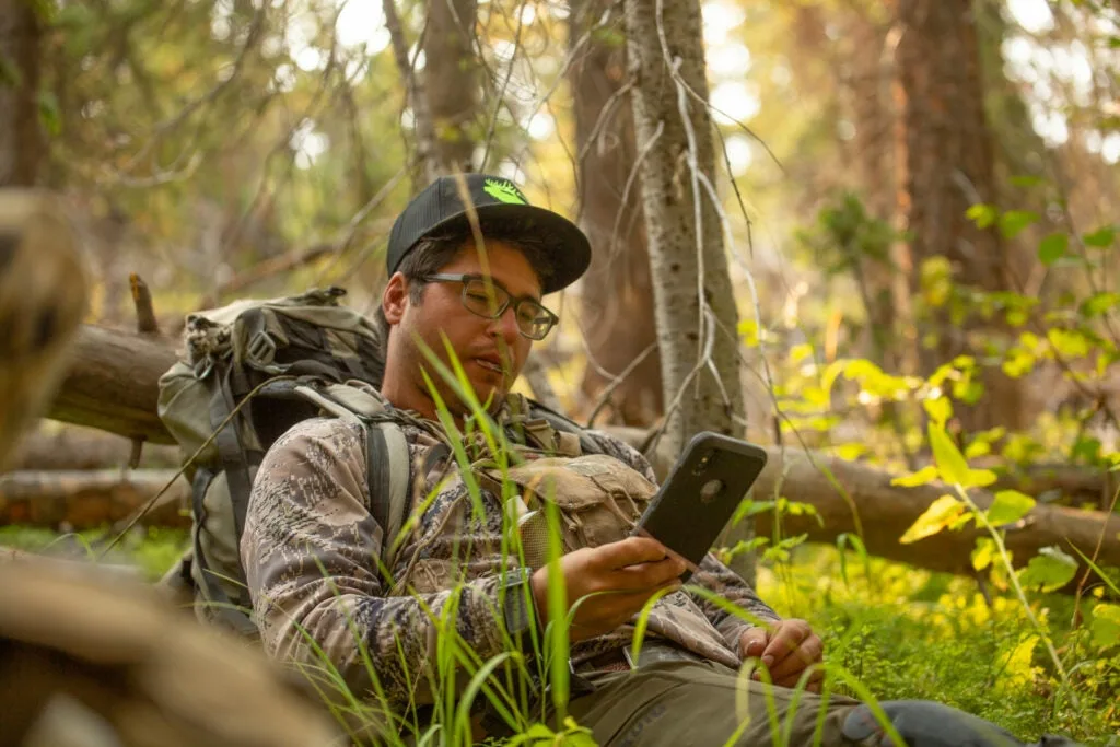 hunter on phone in the woods