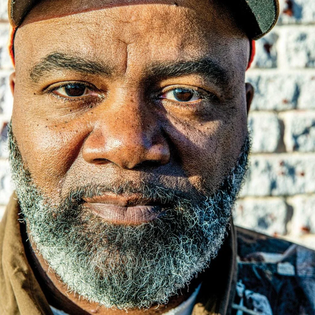 Close up portrait of a black man with a grey and white beard.