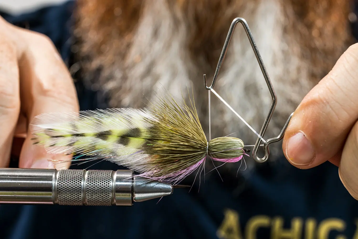 close-up of fly as Brandon Bailes finishes tying it