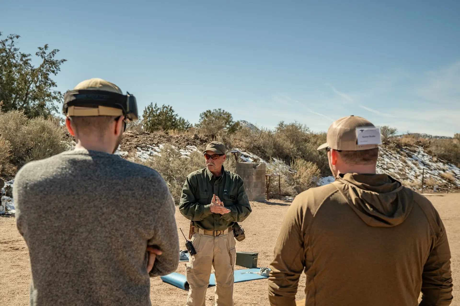 A shooting instructor gives a lesson at a Gunsite shooting range.