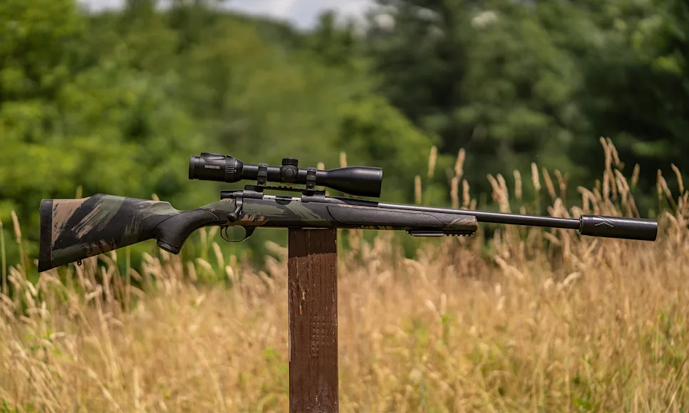 The new Weatherby Vanguard Black Hills bolt-action rifle balanced on a post in a field.