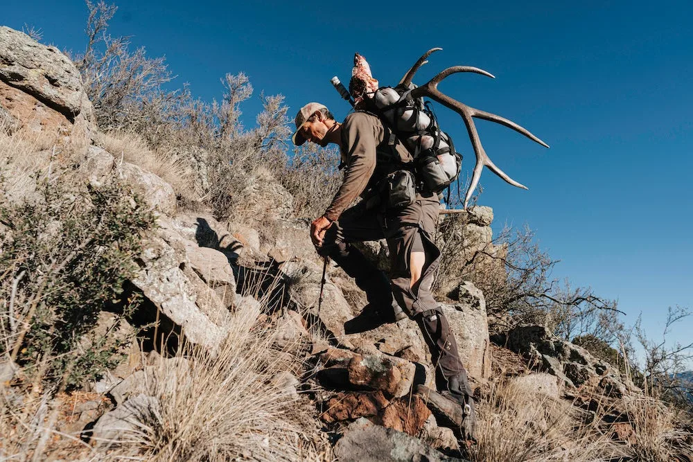 Stone Glacier founder Kurt Racicot hiking mountain with pack and sheep