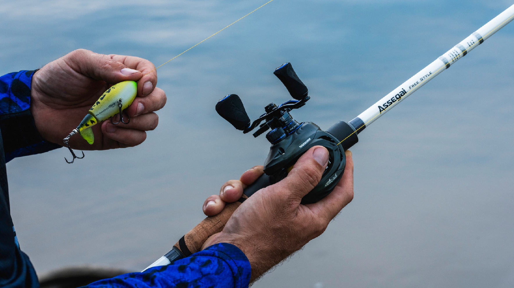 Angler putting lure on KastKing Spinning Reel