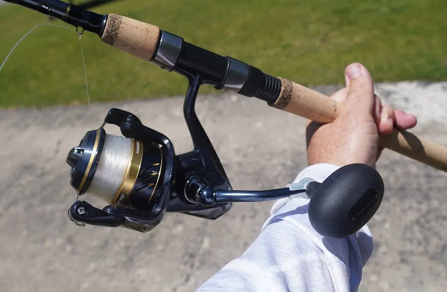 Close-up of angler holding Shimano Spheros spinning combo