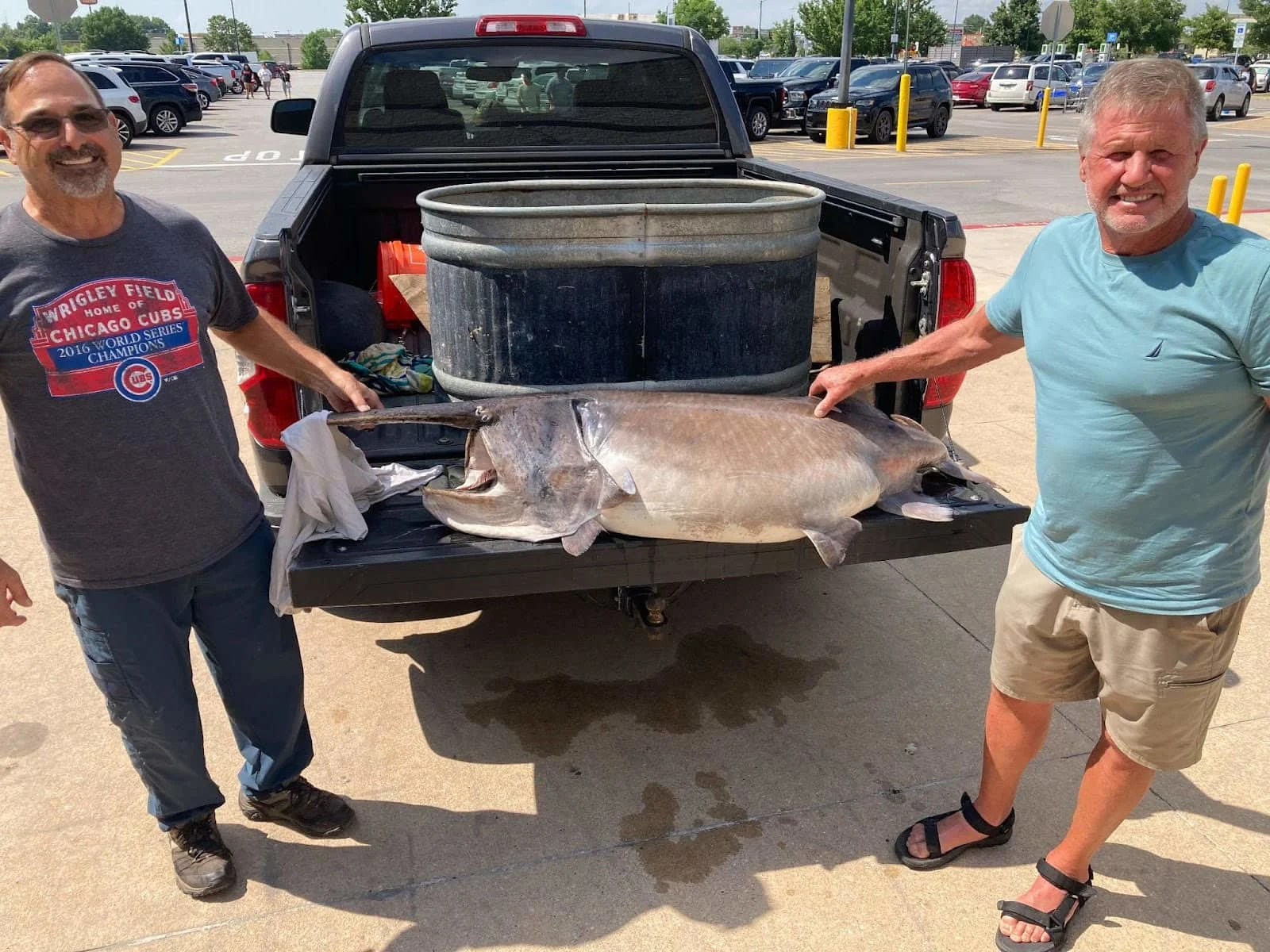 Two fishing buddies pose with a state-record paddlefish.