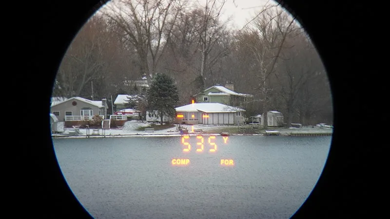 A view of a home across a lake through the Maven RF.1 rangefinder. 