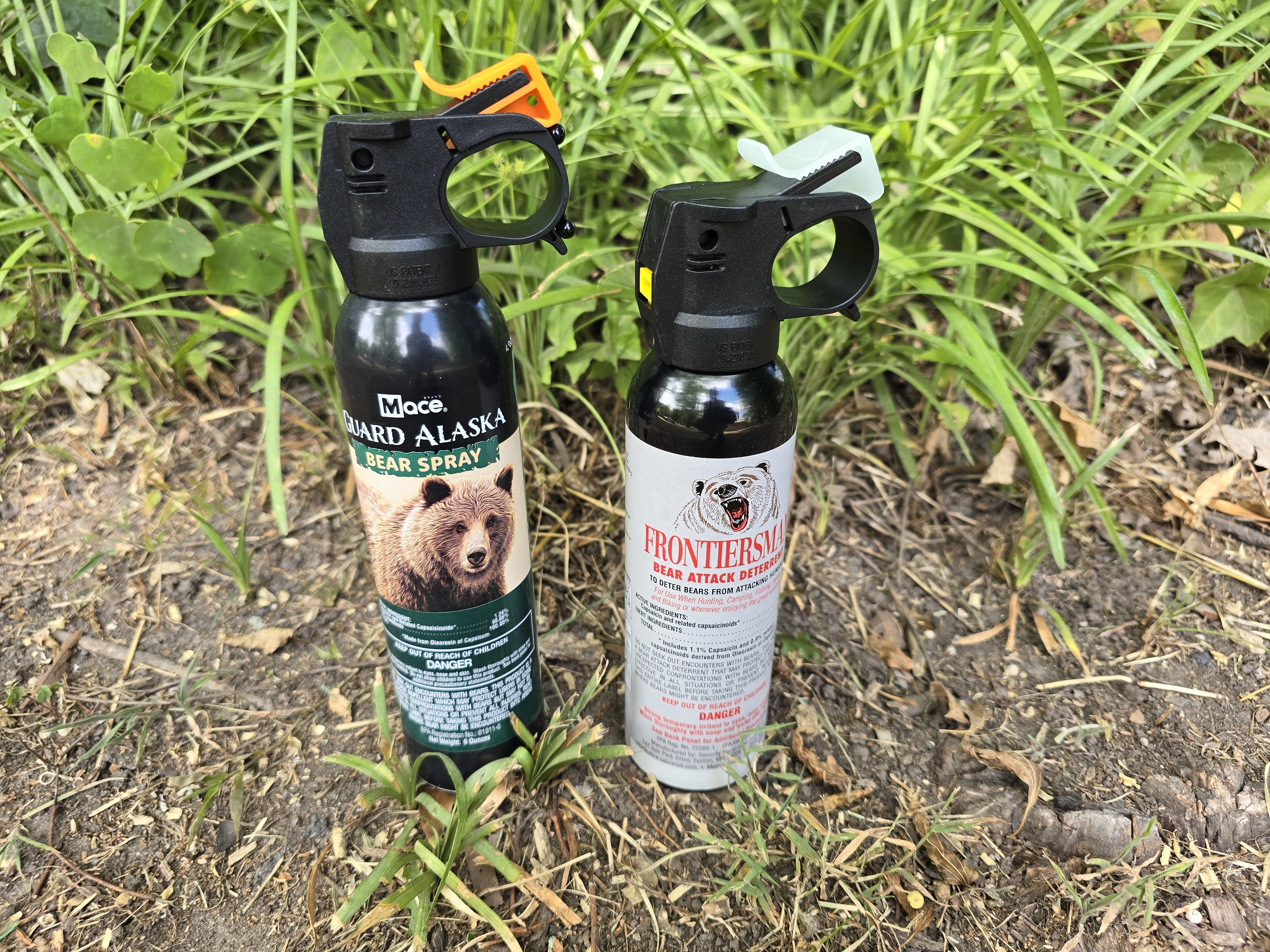 Mace and Frontiersman bear sprays sitting on grass