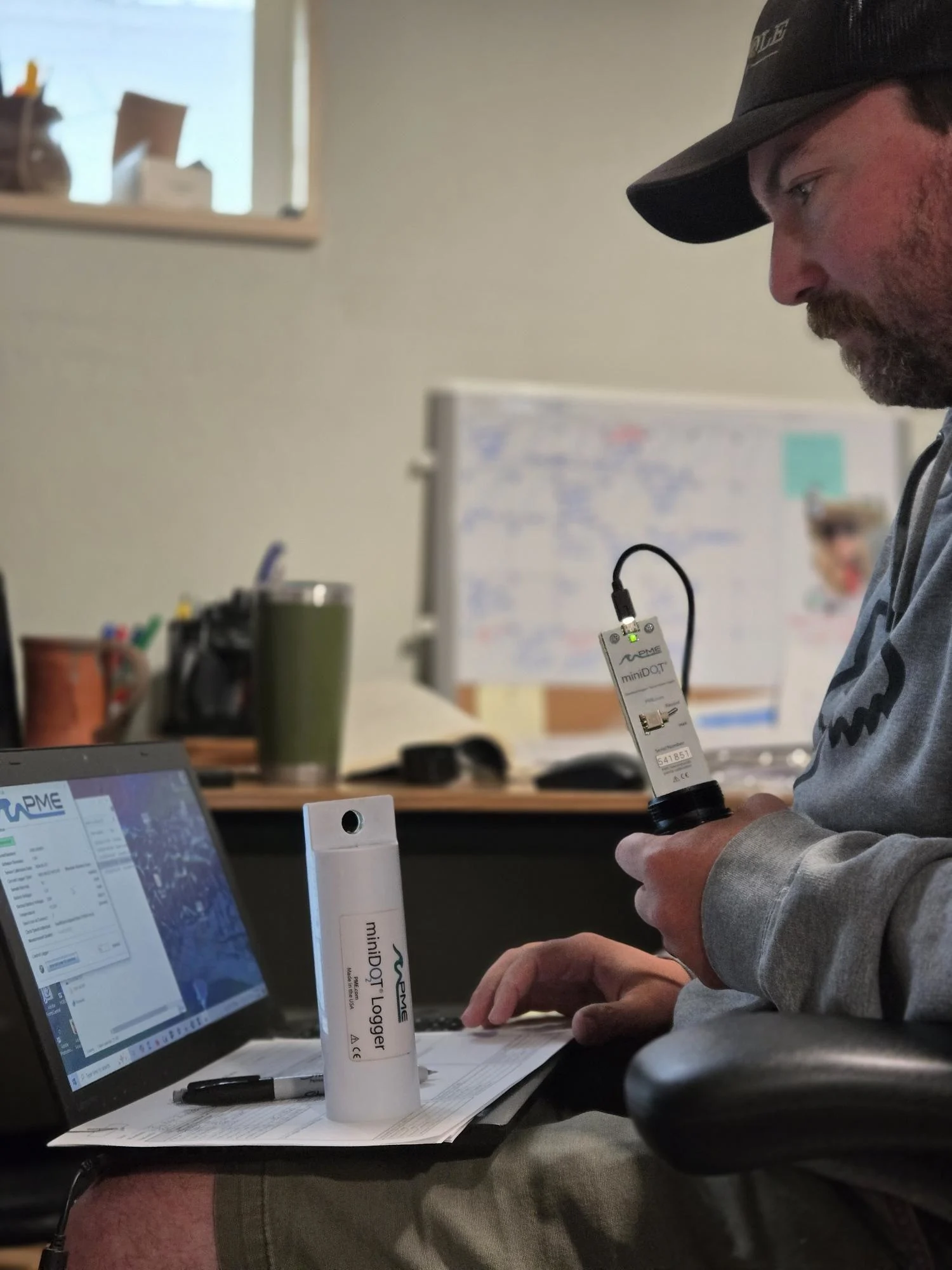A data collector inputs water quality information collected on a Montana trout stream.