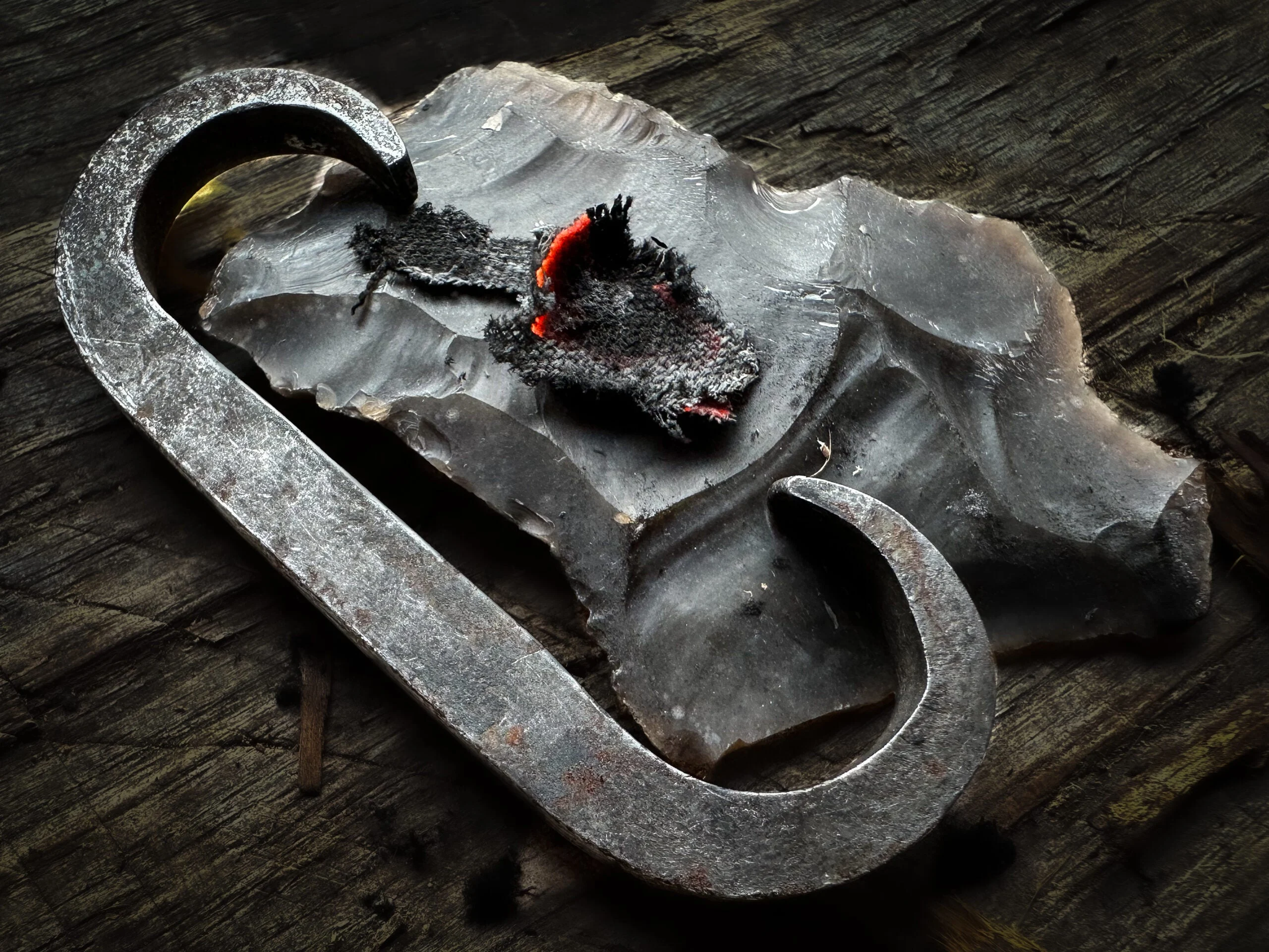 A steel striker and flint used to start a fire.