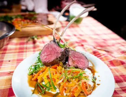 plate of venison with peppers and onions.