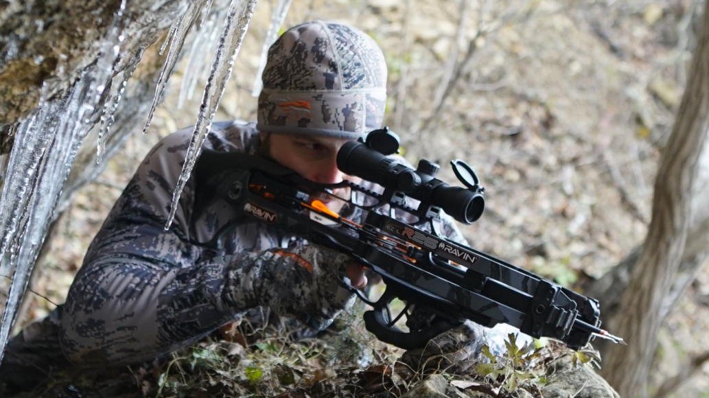 Bowhunter looking through Ravin Crossbow Scope