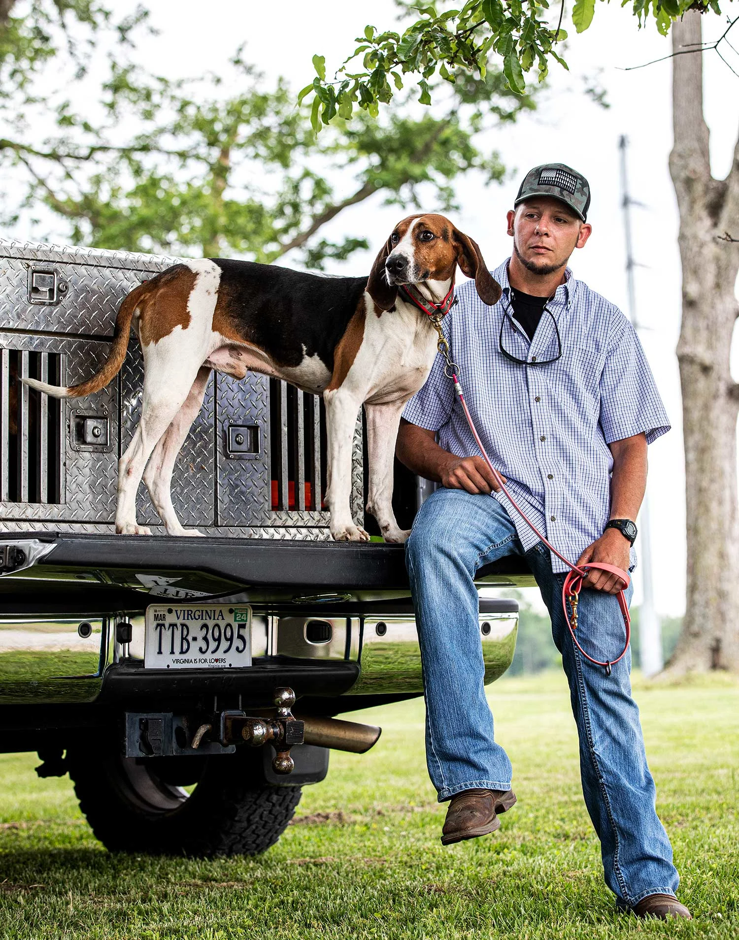 Trey Hewitt and hound Debot pose on truck tailgate