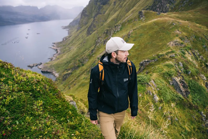 Hiker at top of grassy mountain