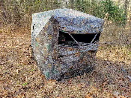 Female hunter inside Game Winner Bushwhacker Hub blind for turkey hunting