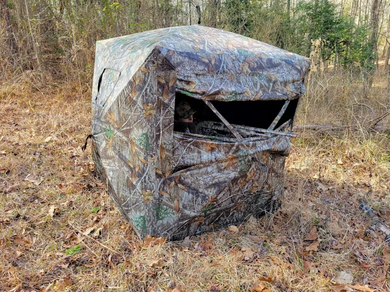 Female hunter inside Game Winner Bushwhacker Hub blind for turkey hunting