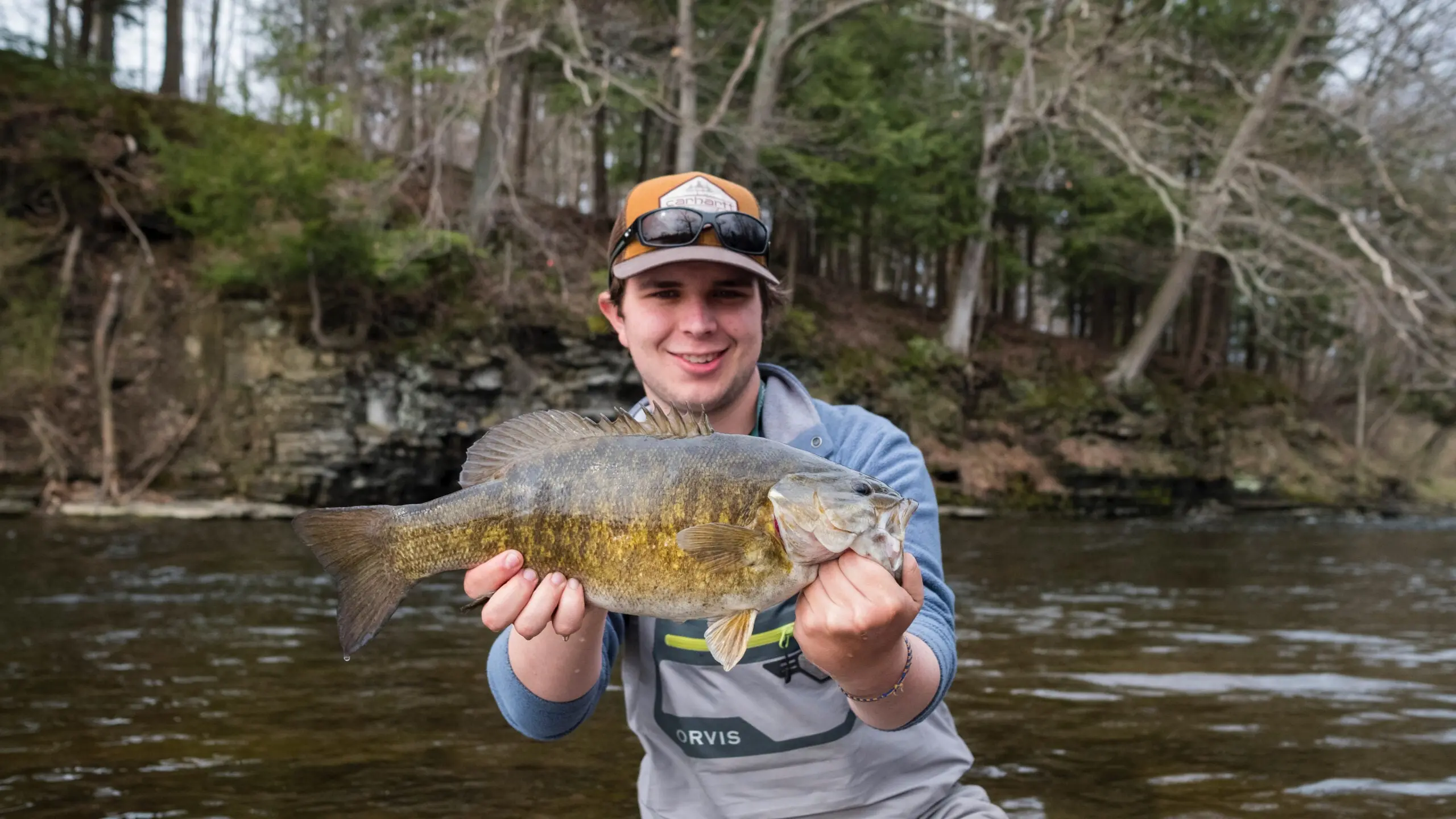 Fisherman holding smallmouth bass