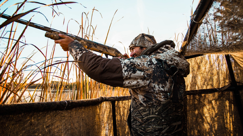 Duck hunter in blind wearing Tidewe Hunting Jacket