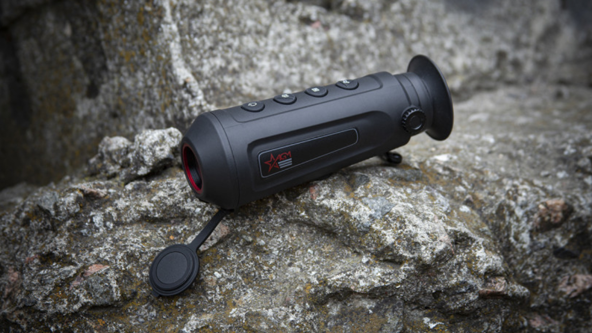 AGM Asp-Micro Thermal Monocular sitting on rock