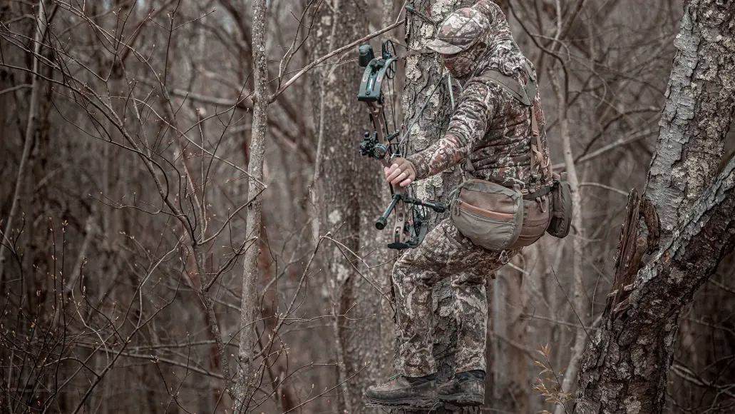 photo of a man bowhunting from a tree saddle