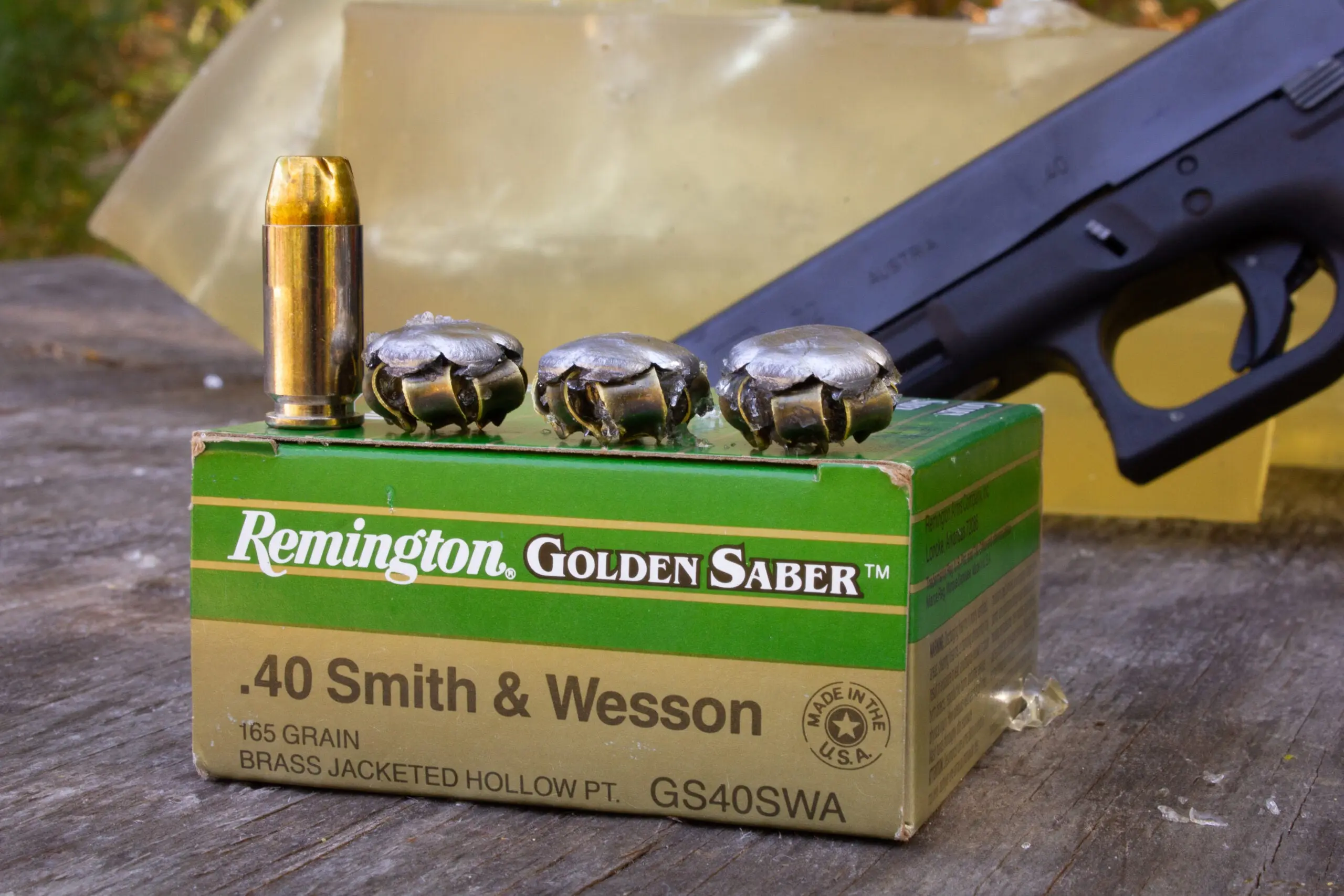 Box of 40 S&amp;W ammo with unfired cartridge and the fired bullets on top