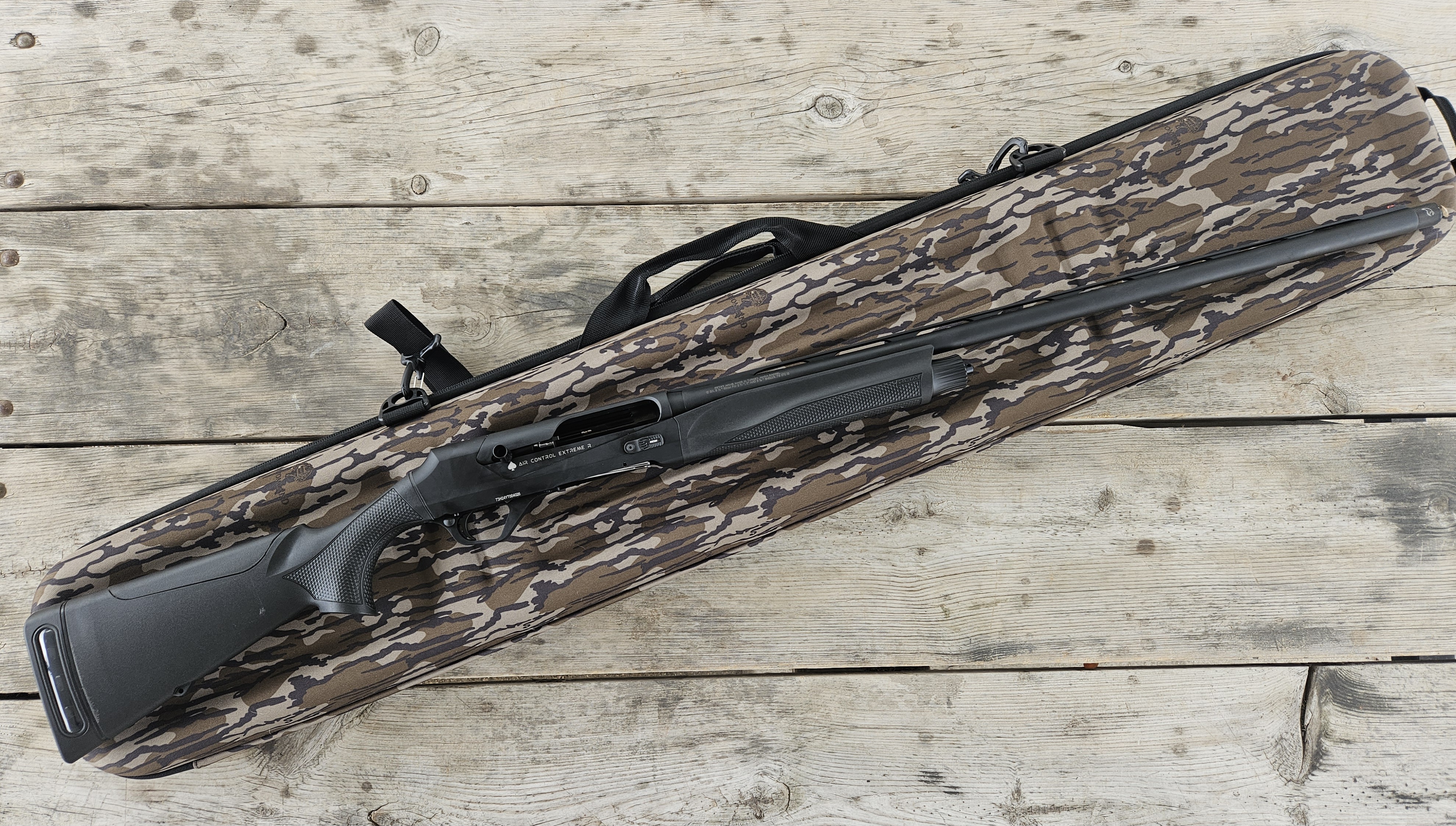 The new Retay ACE-R semiauto shotgun with Plano gun case on a wood surface.