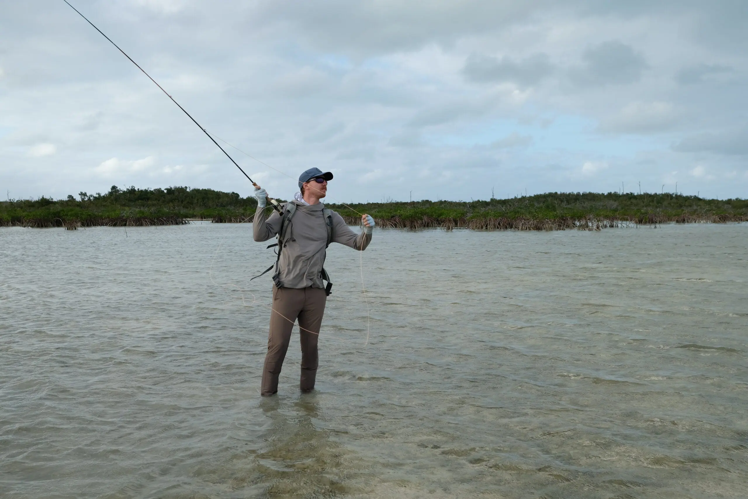 fly fisherman makes a cast