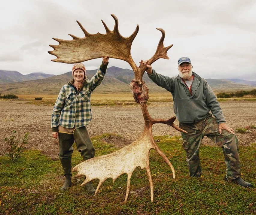 A pair of Alaska hunting guides show off a massive set of moose antlers.