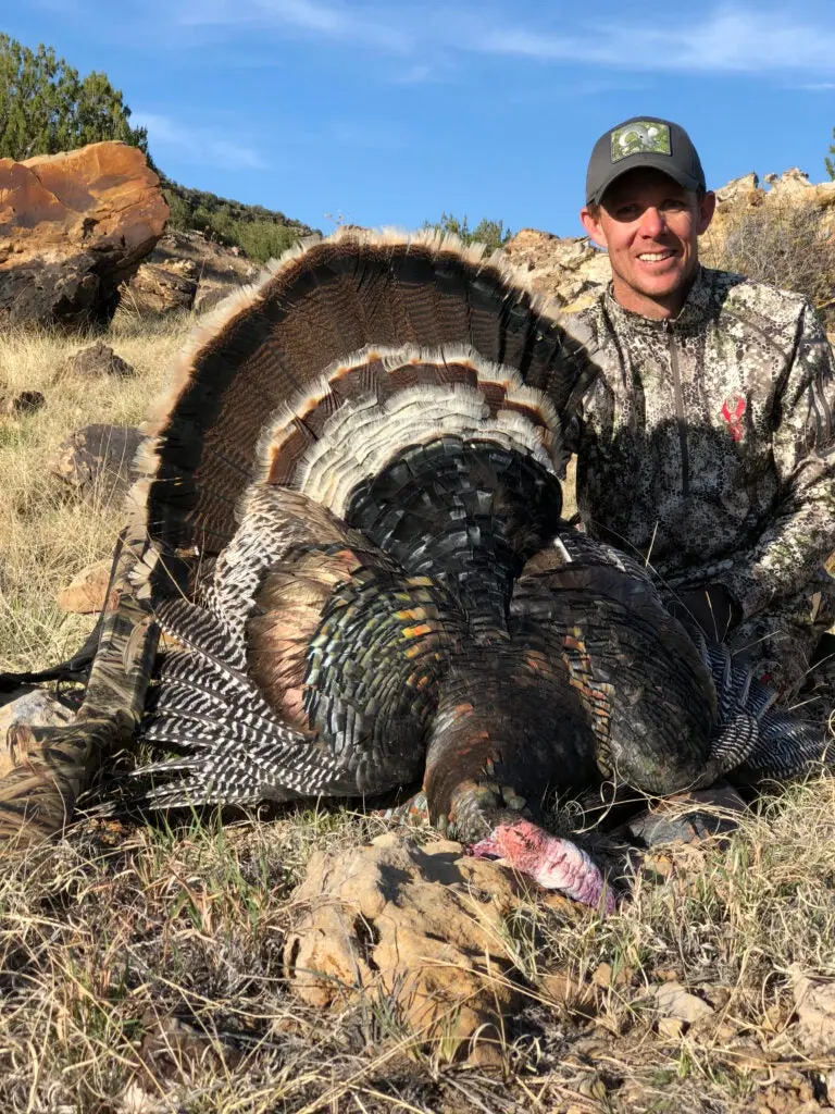 photo of hunter with wild turkey