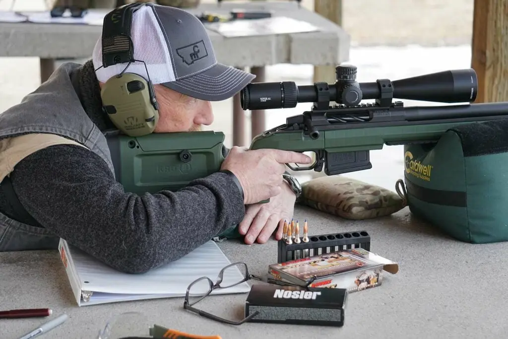 aiming a rifle while testing ammo