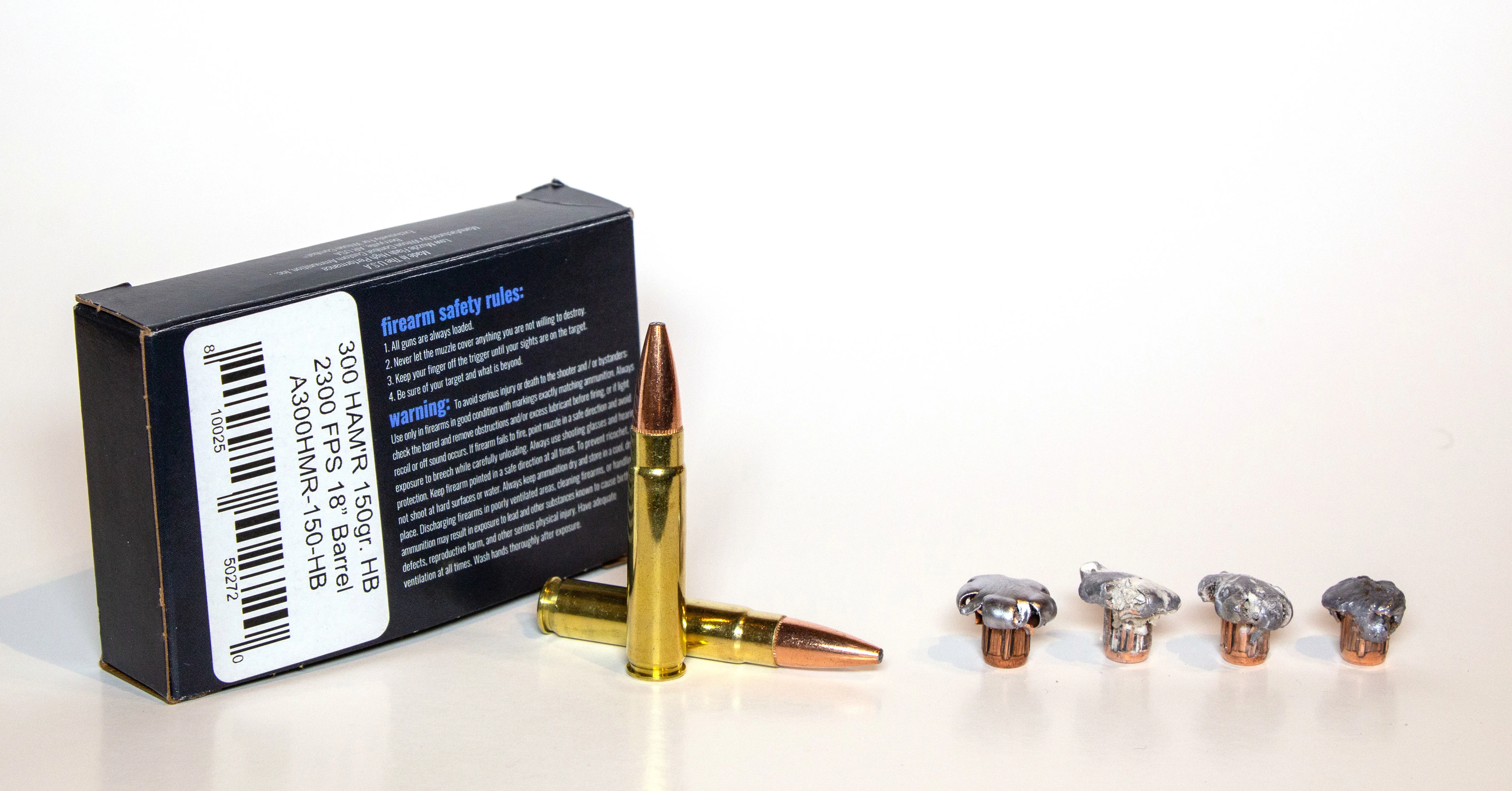 Four 300 HAMR bullets after firing next to two un-fired cartridges.