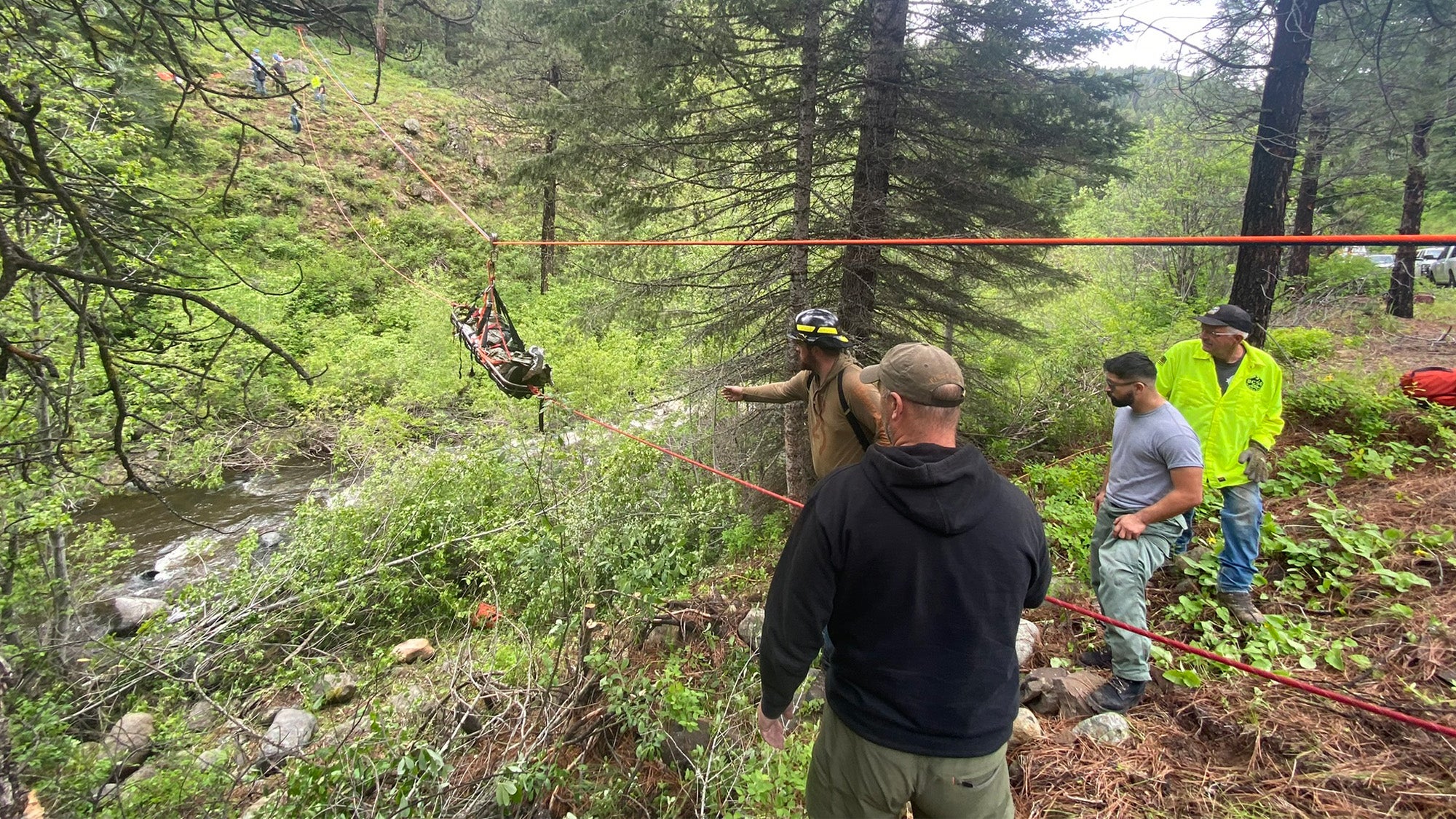 man being lifted in a basket from a car rescue