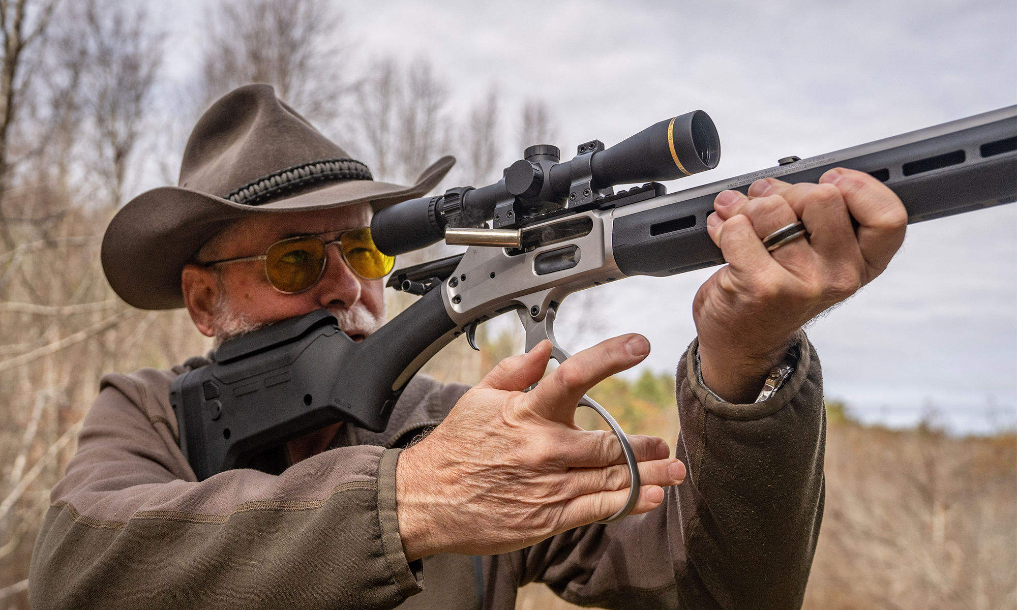 A shooter works the action of a lever-action rifle.