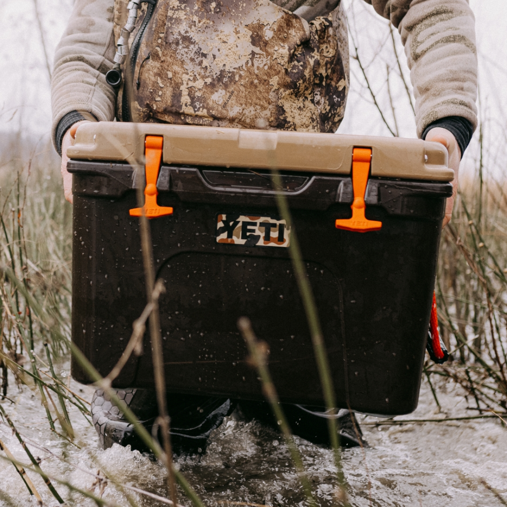 Hunter carrying Yeti Wetlands Brown Loadout GoBox gear case