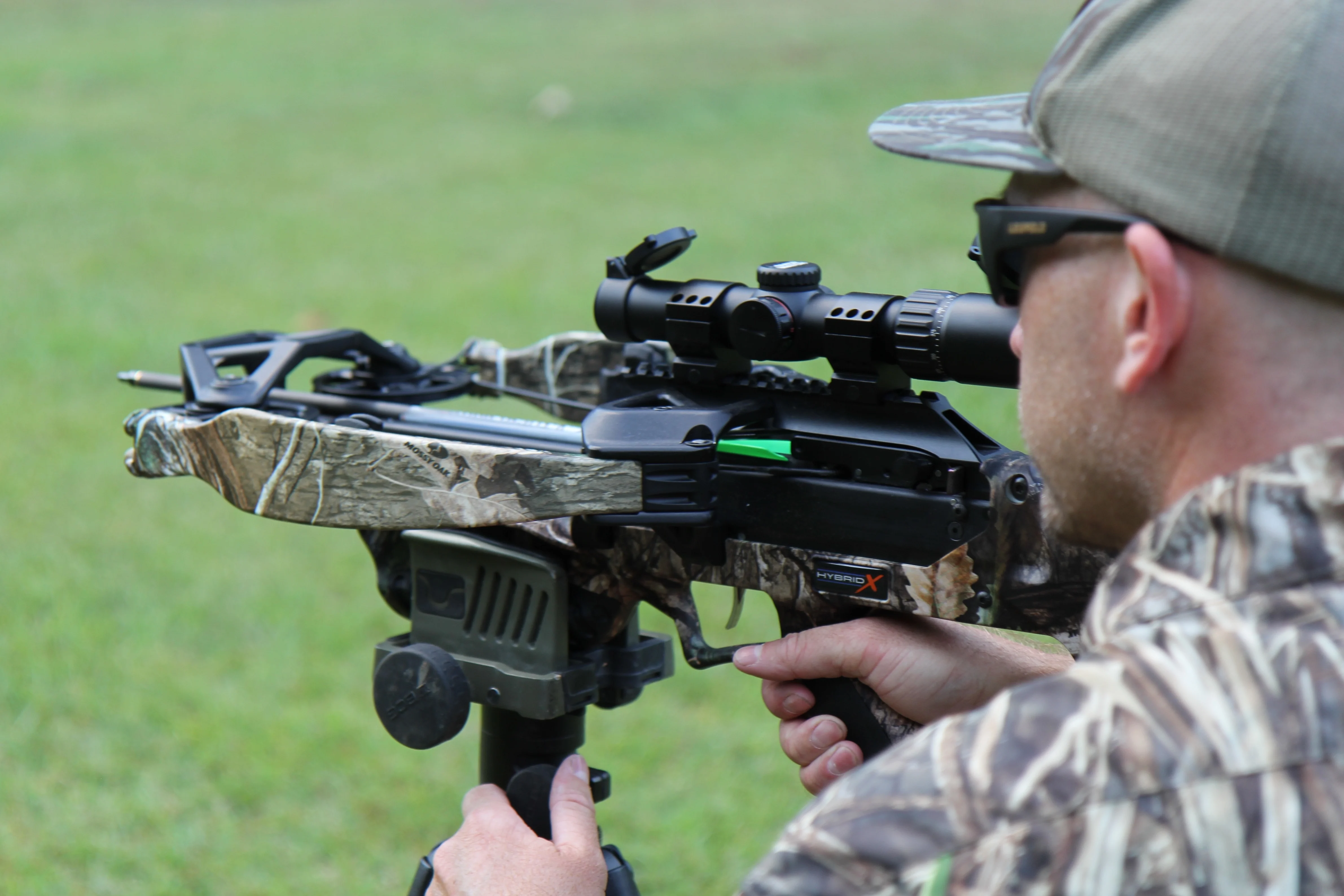 A man shoots the Excalibur Hybrid X crossbow in a yard. 