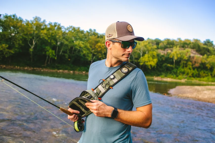 Angler in river wearing a sling pack