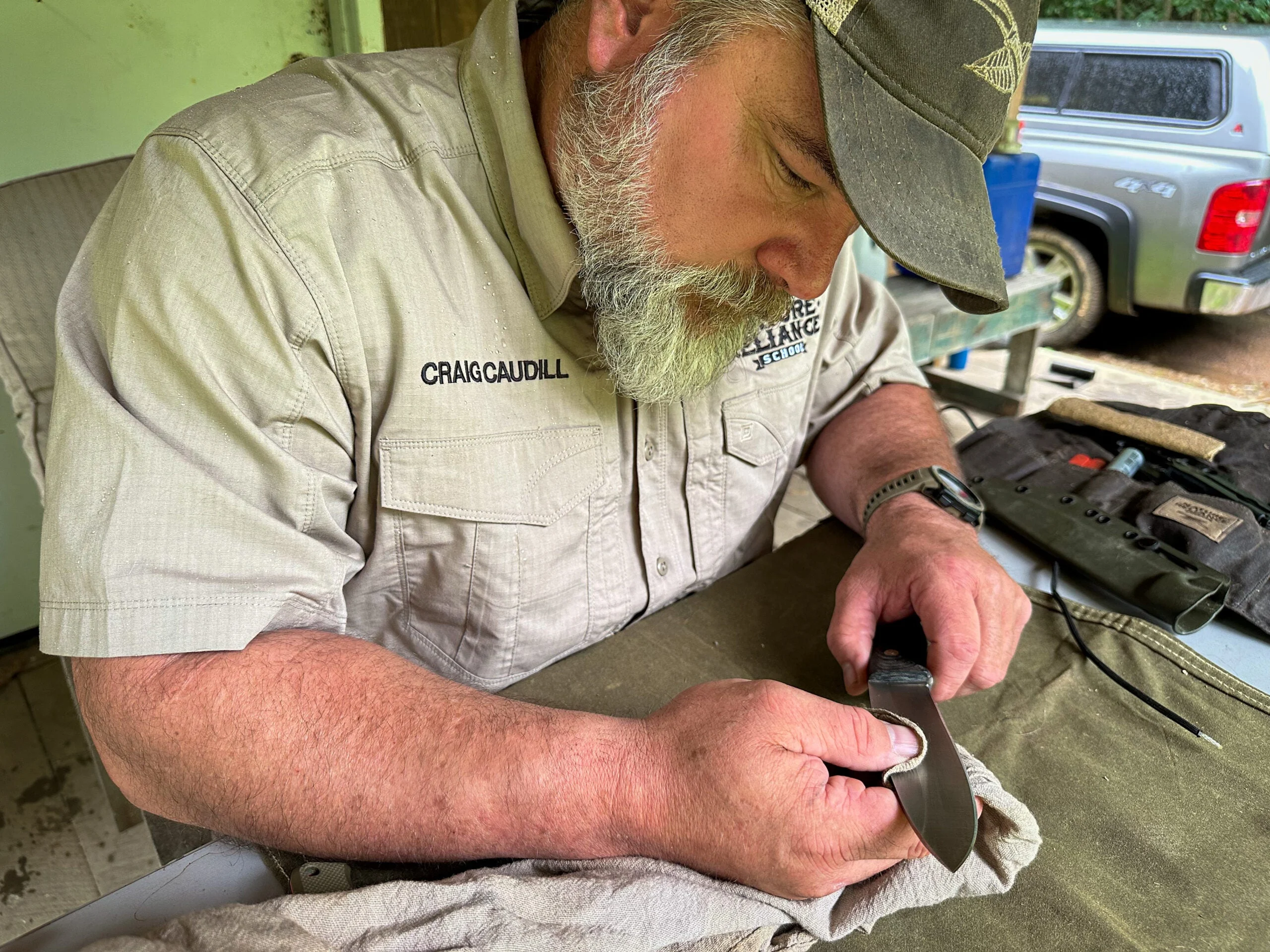 Examining a knife blade before sharpening.