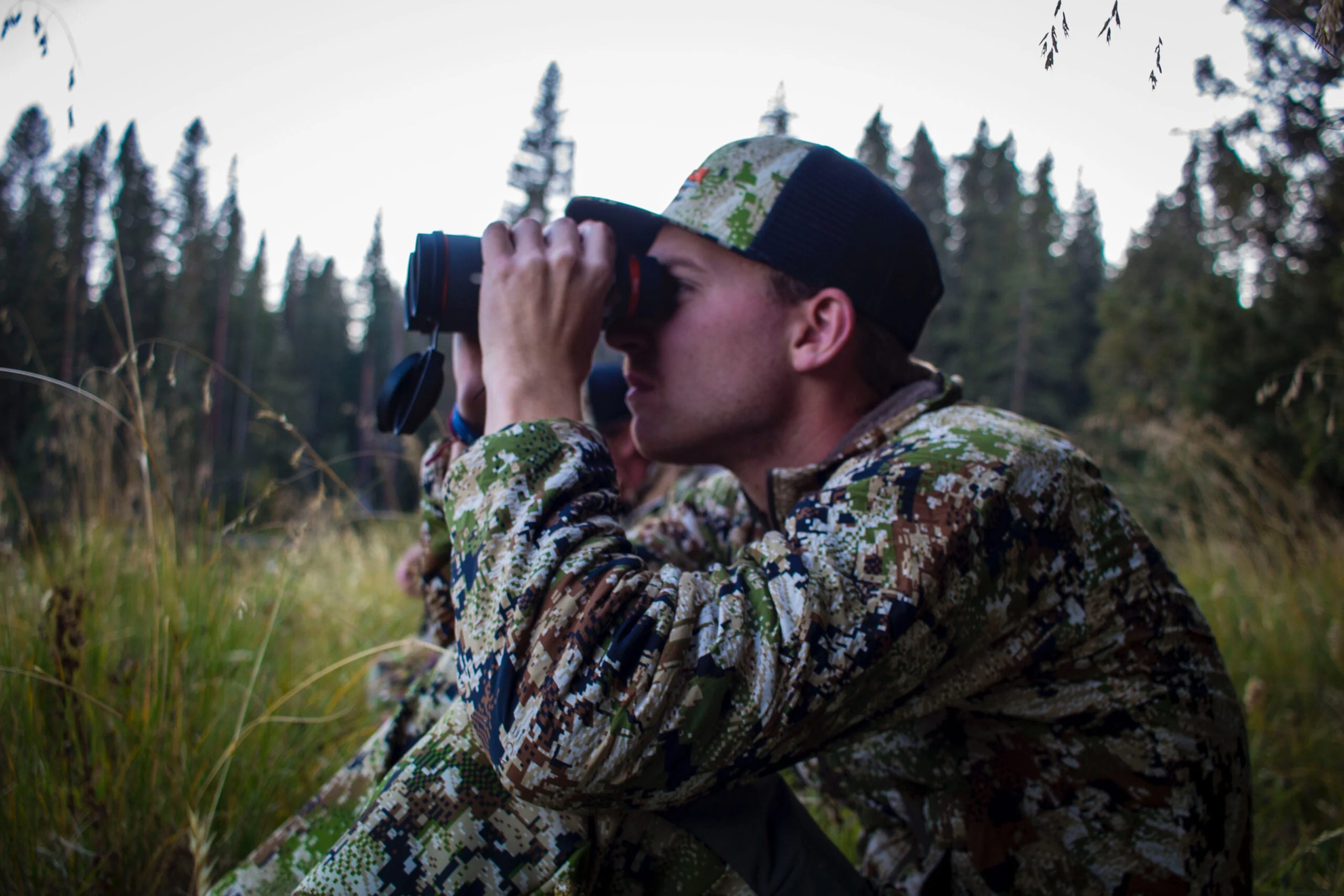 Associate Editor, Ryan Chelius, glasses a hillside on an archery elk hunt.