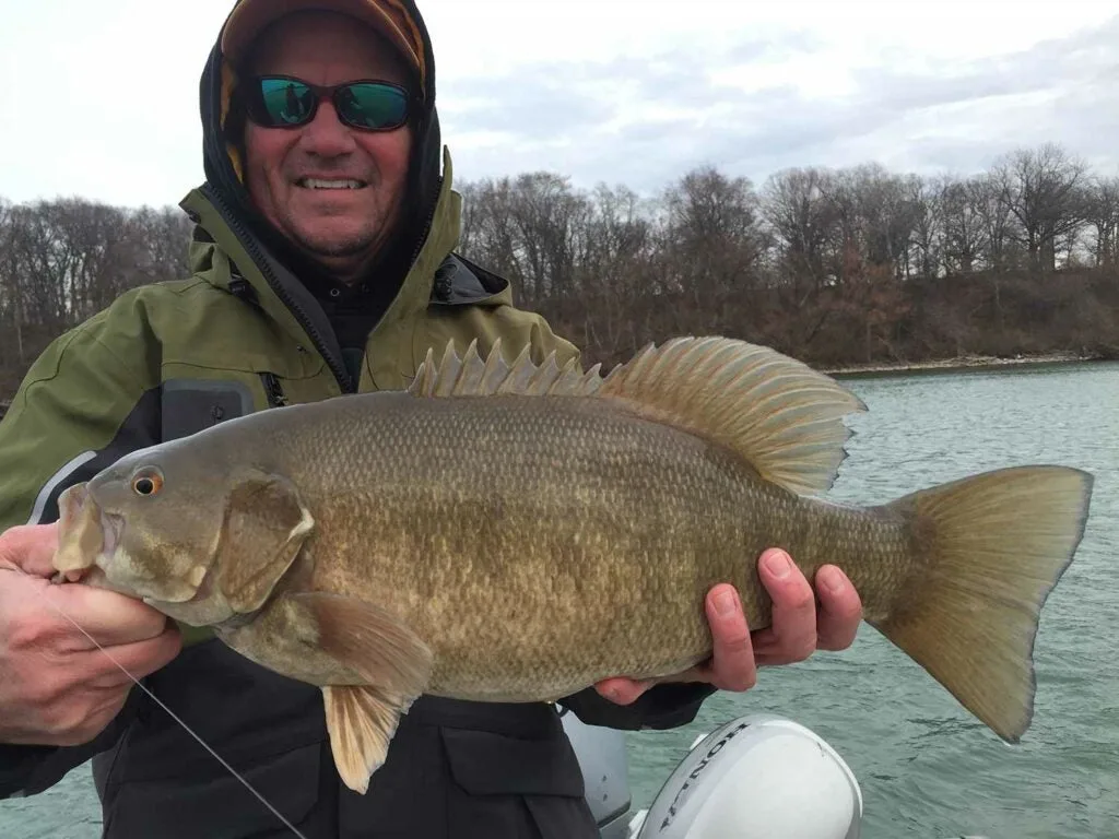 angler holding up a smallmouth bass