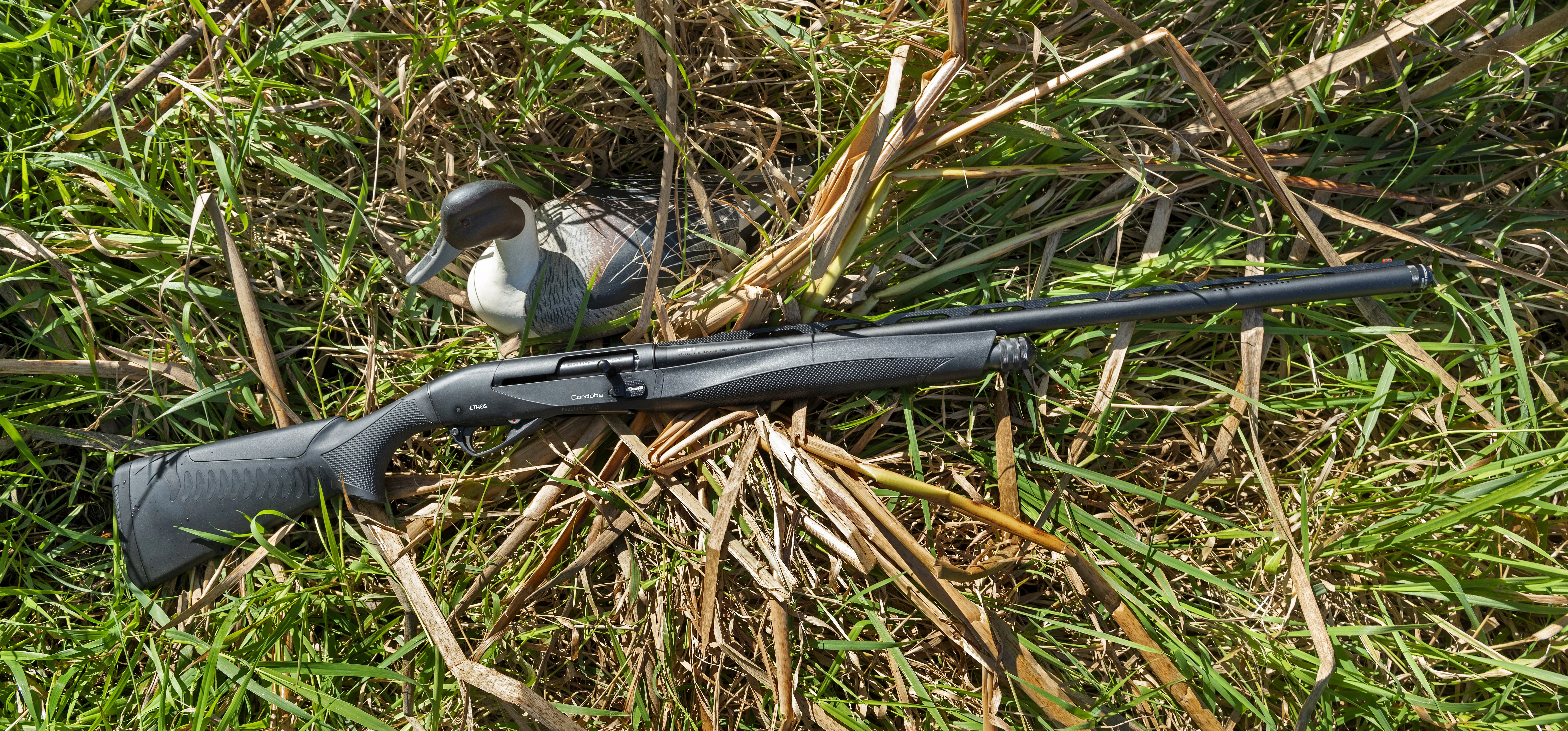 Benelli Performance Shop Ethos Cordoba A.I. BE.S.T. in grass with a duck decoy. 