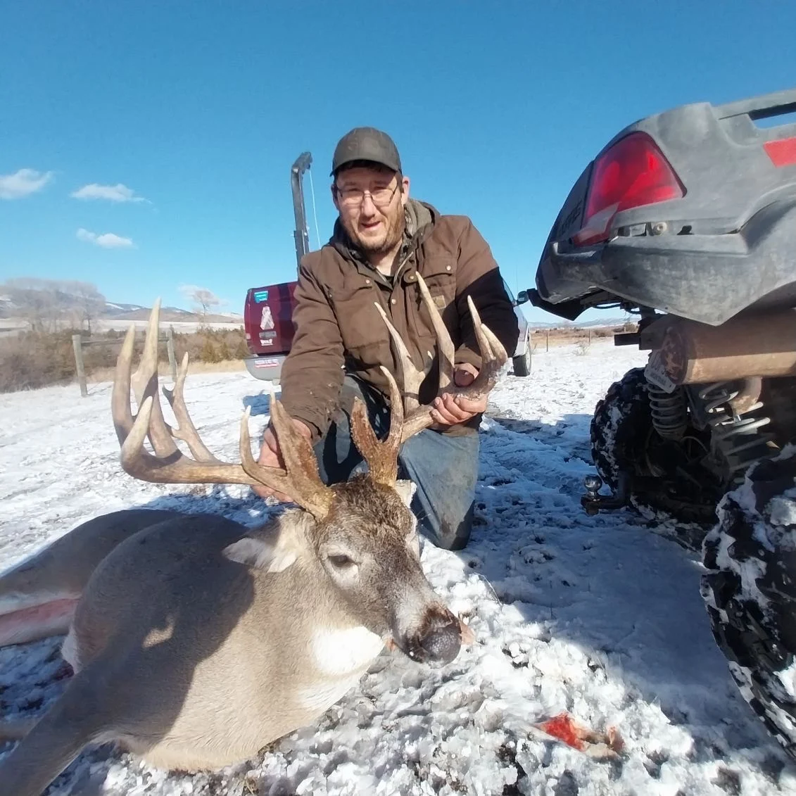 A hunter poses with a giant whitetail buck taken in Montana. 