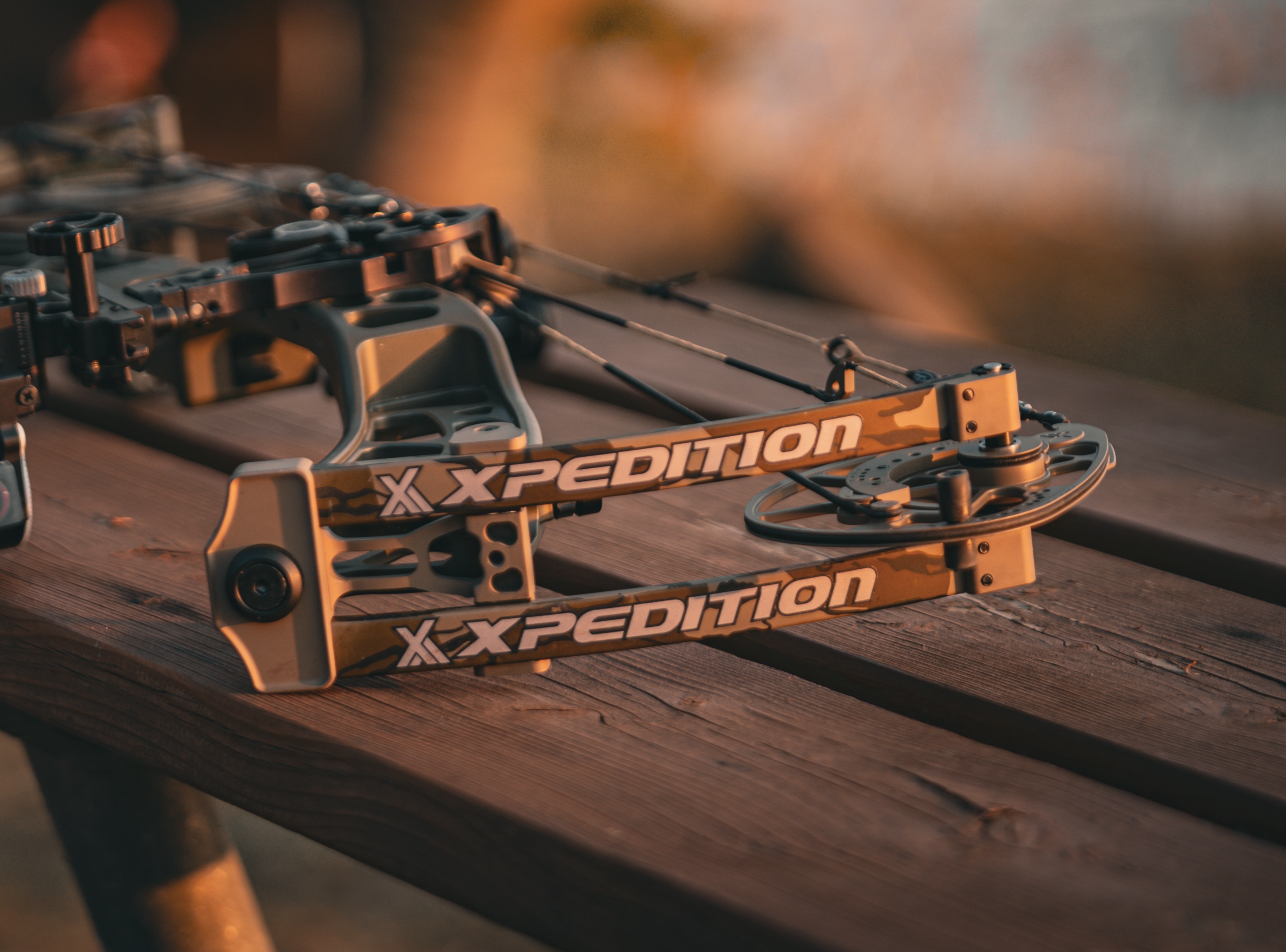 The new Xpedition Xlite 32 compound bow resting on an outdoor bench.  