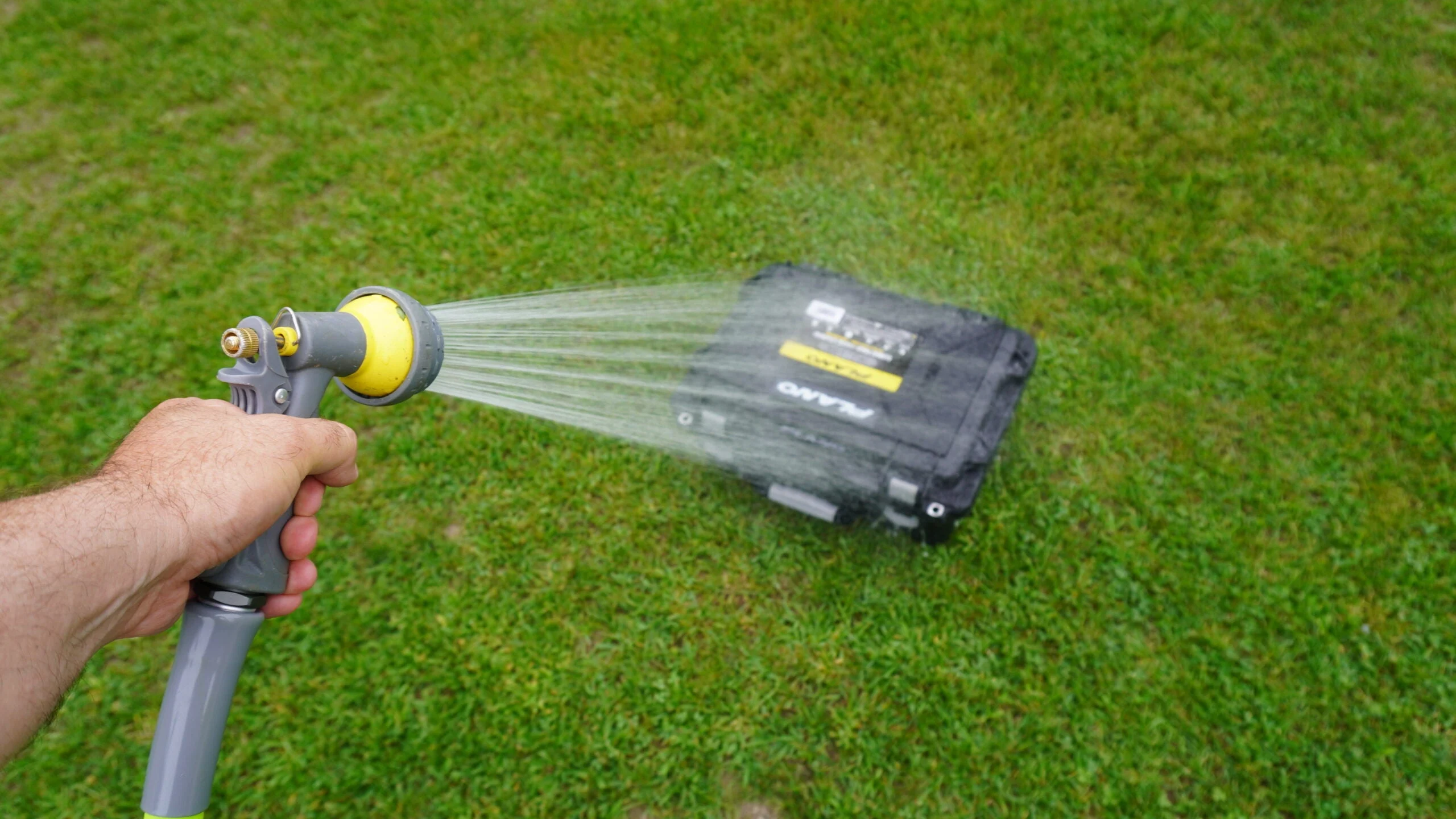 Man testing waterproof capabilities of pistol case