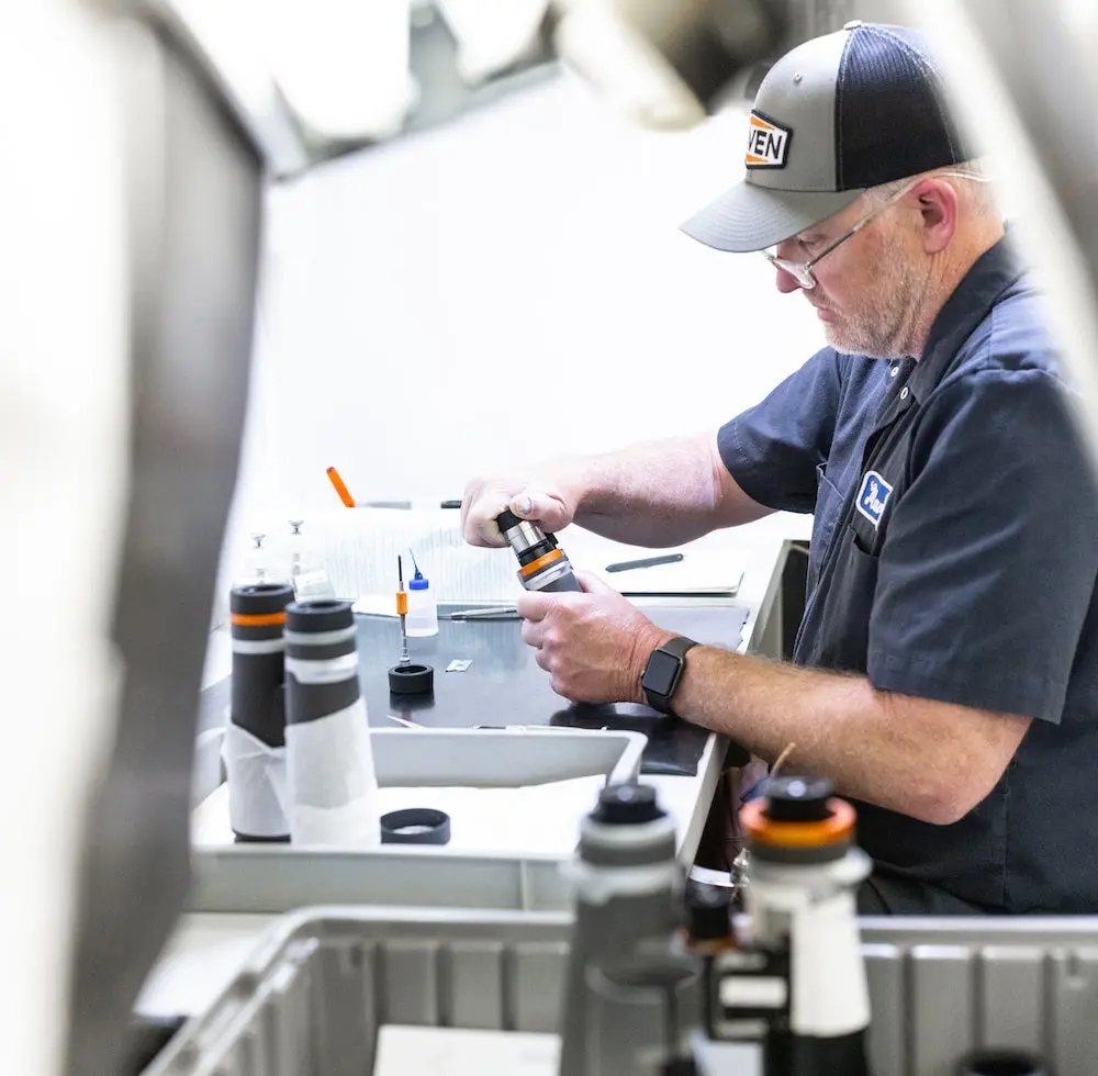 Maven Optics co-founder Brendon Weaver working in the warehouse