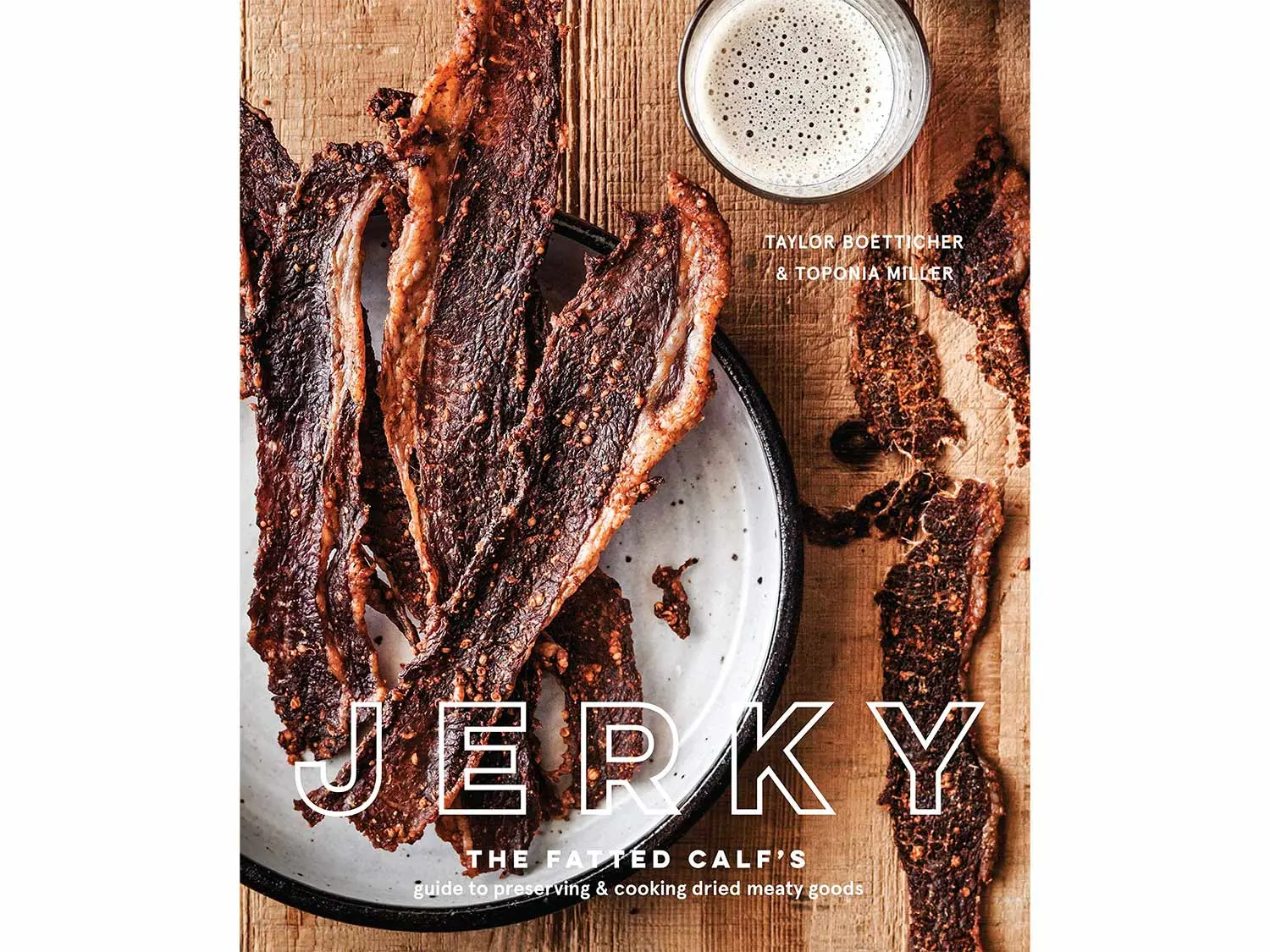 A book cover with beef jerky on a wooden table.