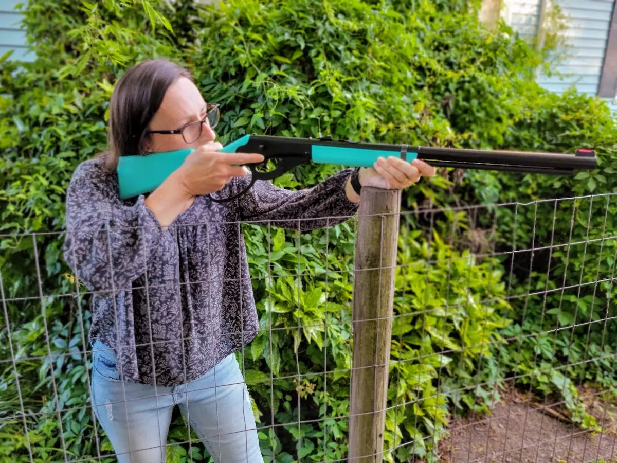 Female shooter aiming a Daisy Carbine BB gun