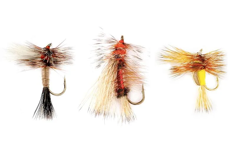 Three fly fishing lures on a white background.