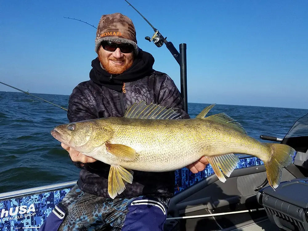 fisherman holding up a giant walleeye