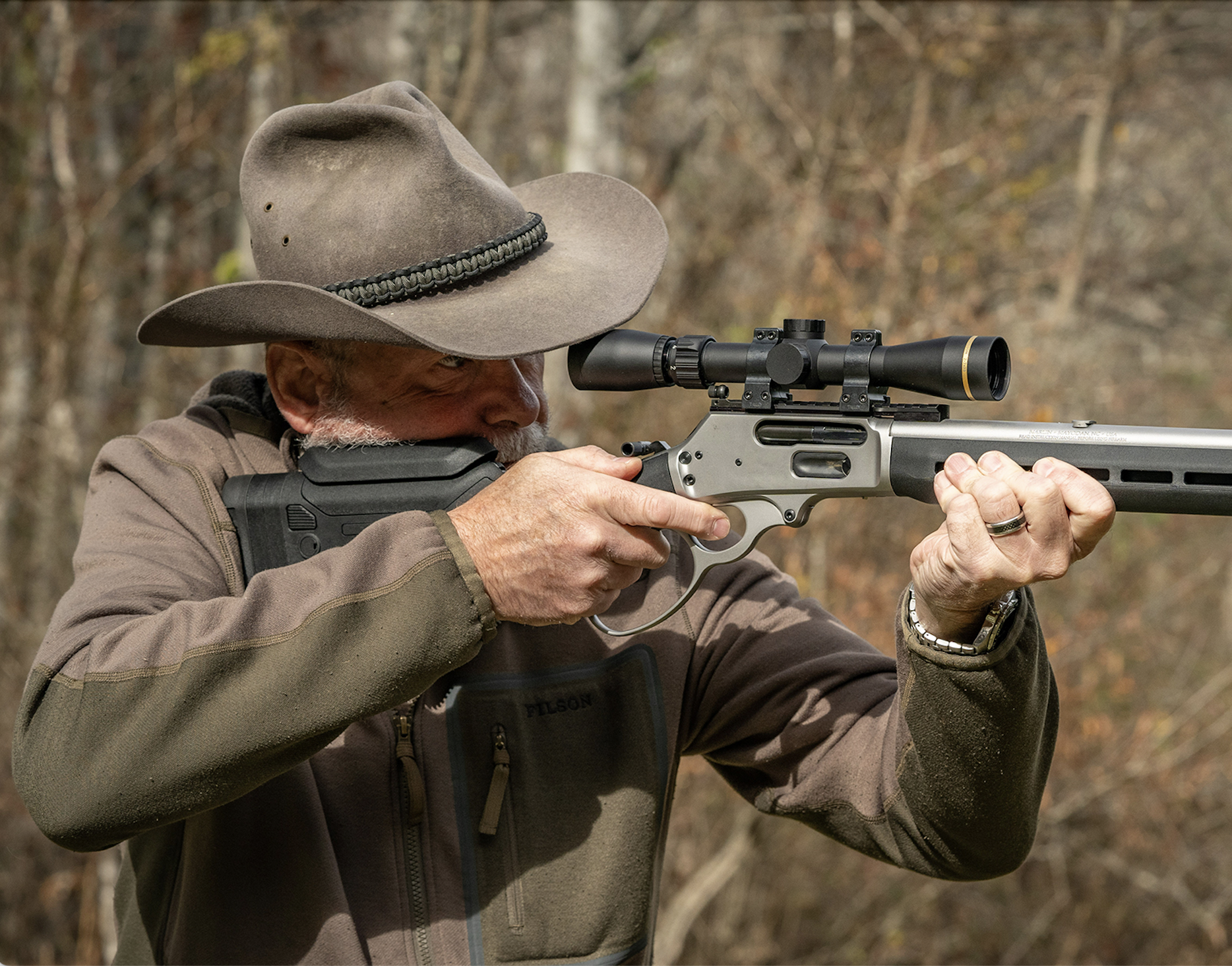 A shooter fires a Marlin 1895 Trapper lever gun on an outdoor range. 